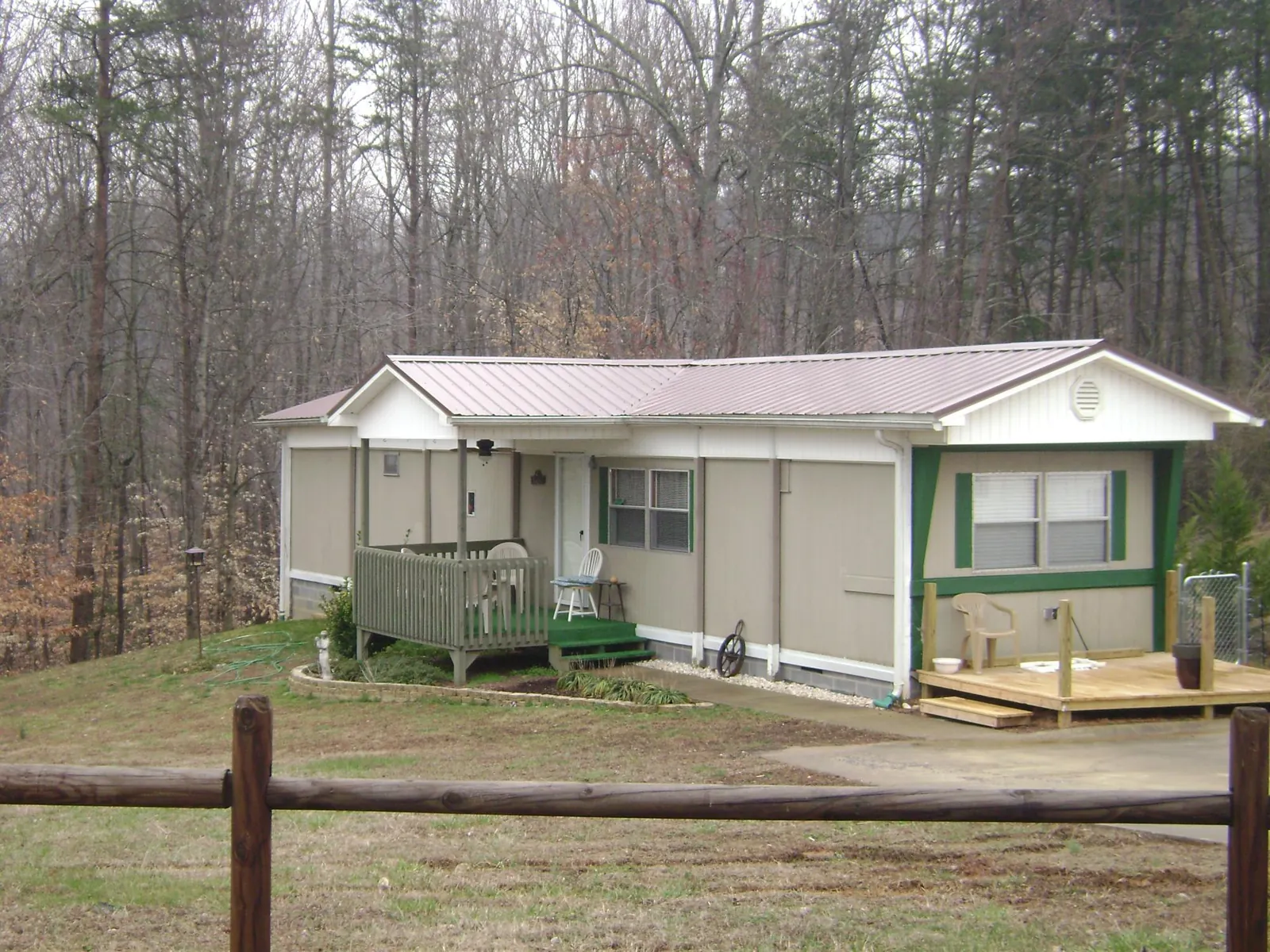 Mauve metal roof on a manufactured home with a new front deck in Logan
